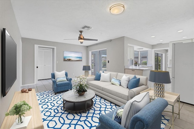 living room with visible vents, recessed lighting, light tile patterned flooring, baseboards, and ceiling fan