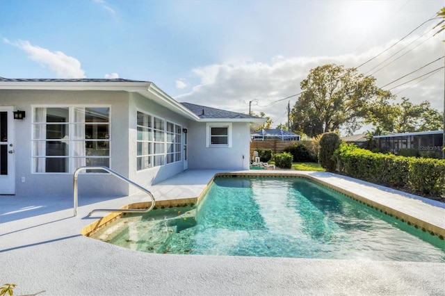 view of swimming pool with a fenced in pool, a patio area, and fence