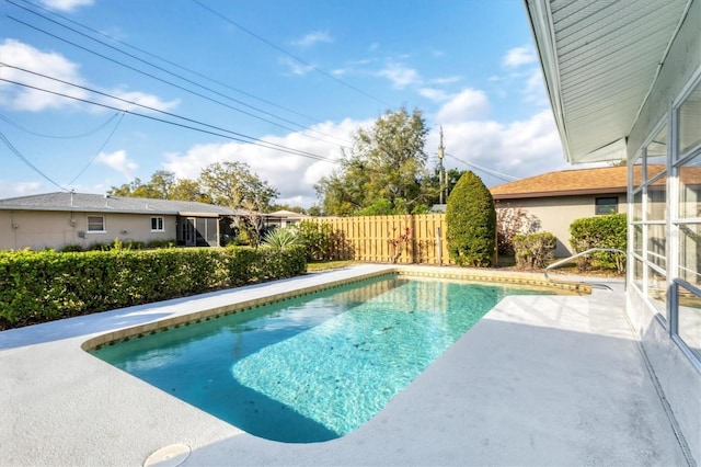 view of pool with a patio area, a fenced in pool, and fence