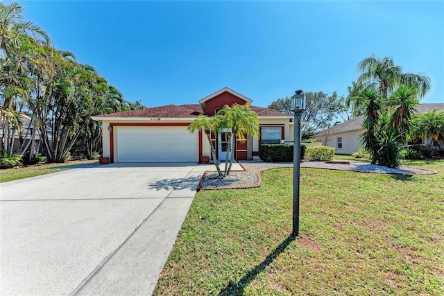 view of front of home featuring a front yard, driveway, an attached garage, and stucco siding