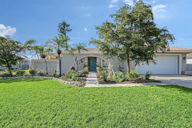 view of front of home featuring an attached garage, driveway, a tiled roof, stucco siding, and a front yard