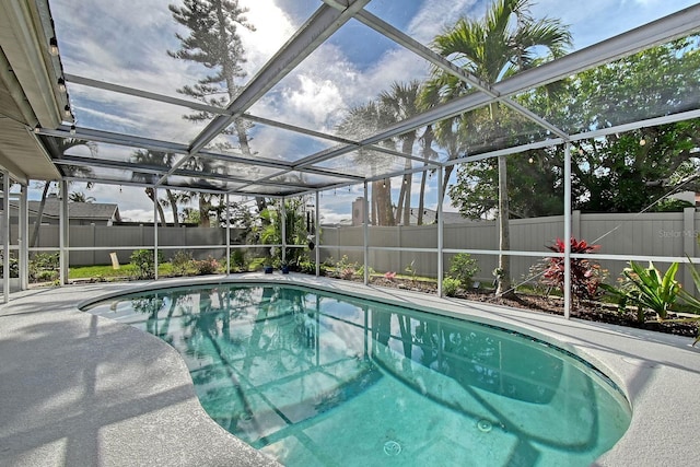 view of pool featuring a fenced in pool, a lanai, a fenced backyard, and a patio