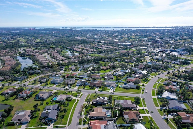 drone / aerial view with a water view and a residential view