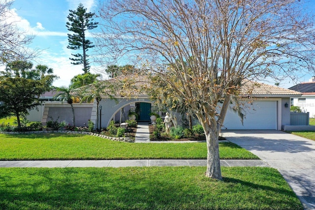 obstructed view of property featuring a tile roof, stucco siding, concrete driveway, an attached garage, and a front yard