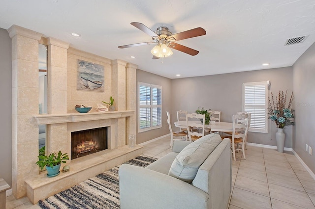 living room with a wealth of natural light, light tile patterned flooring, and visible vents