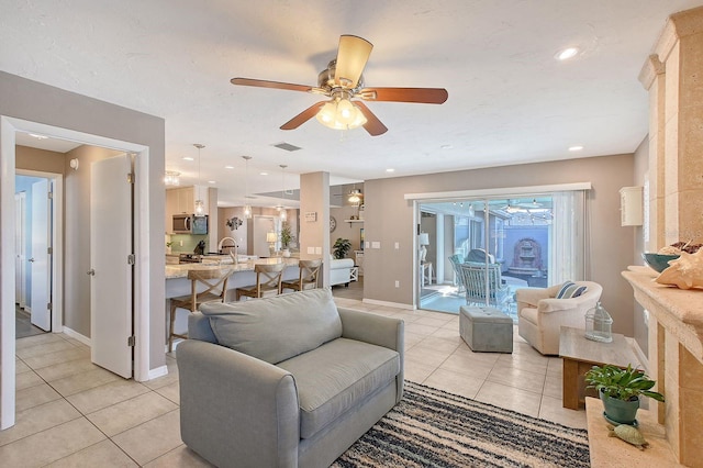 living room featuring light tile patterned floors, recessed lighting, visible vents, baseboards, and a ceiling fan