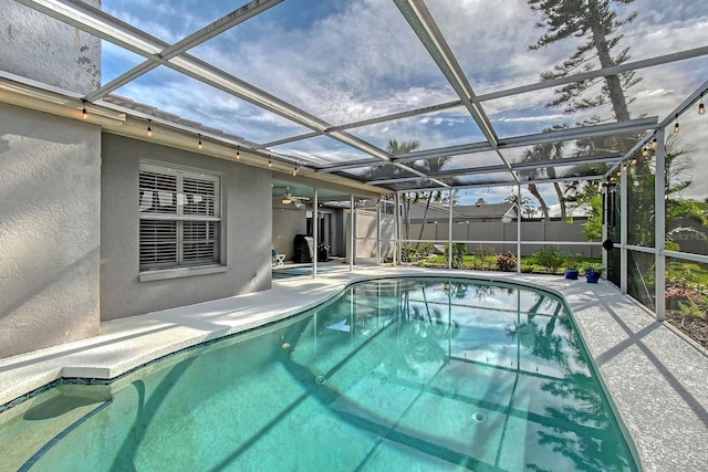 view of swimming pool featuring a lanai, a patio area, fence, and a fenced in pool