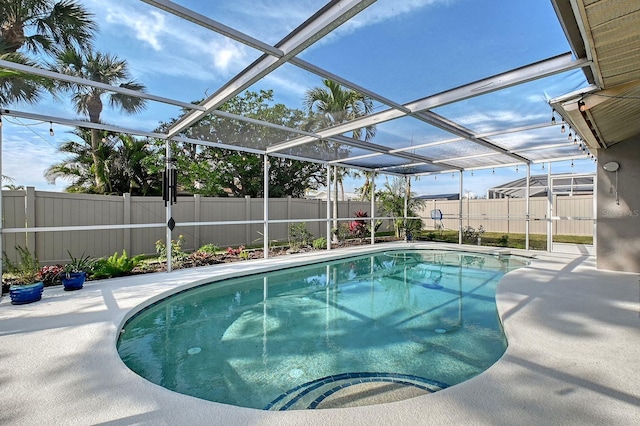 view of swimming pool featuring a patio area, a fenced backyard, a fenced in pool, and a lanai