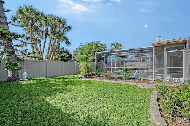 view of yard with glass enclosure, a fenced backyard, and a swimming pool