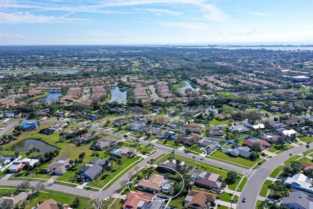 birds eye view of property with a water view and a residential view