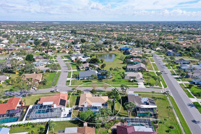 birds eye view of property with a residential view and a water view