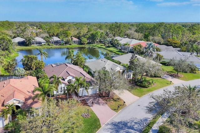 bird's eye view with a wooded view, a water view, and a residential view