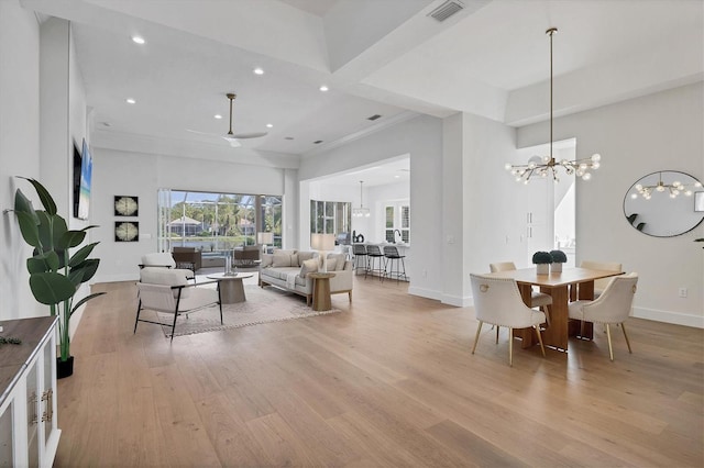 living area featuring baseboards, light wood finished floors, visible vents, and recessed lighting