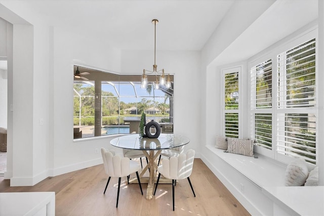 dining room with plenty of natural light, baseboards, ceiling fan, and wood finished floors