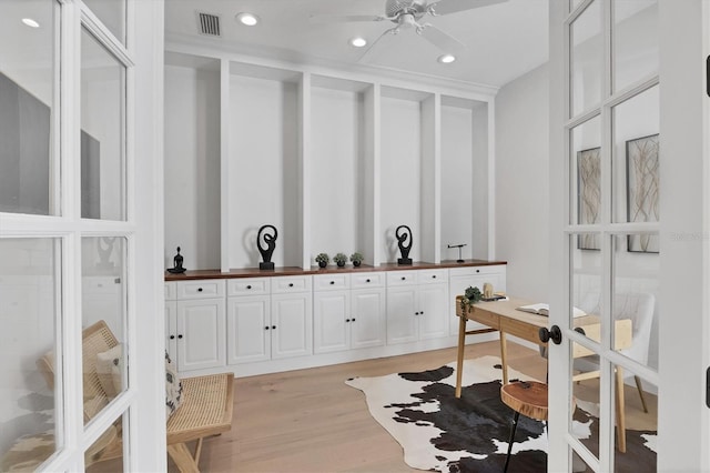 office space featuring light wood-style floors, visible vents, a ceiling fan, and recessed lighting