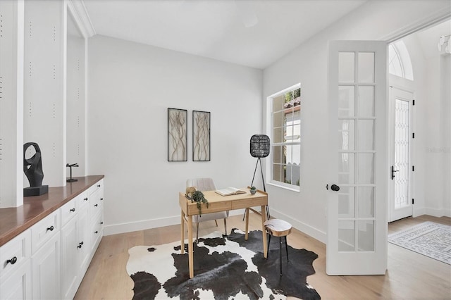 office area featuring light wood-style floors and baseboards