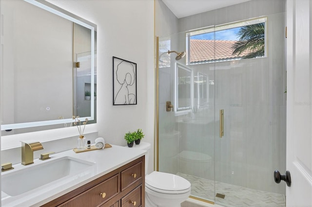 full bathroom with a stall shower, vanity, and toilet