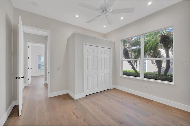 unfurnished bedroom with light wood-style floors, recessed lighting, a closet, and baseboards