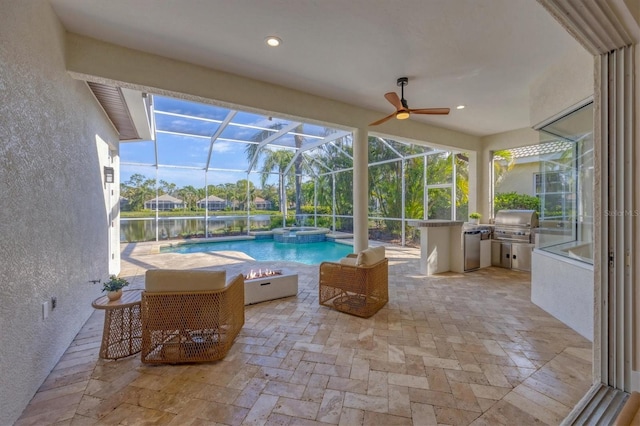 view of pool with a patio, a pool with connected hot tub, grilling area, glass enclosure, and ceiling fan