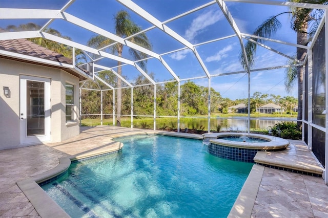 view of pool featuring a water view, a patio area, a pool with connected hot tub, and a lanai