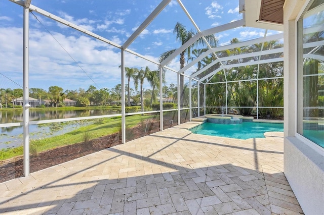 view of pool featuring a patio, a water view, a lanai, and a pool with connected hot tub