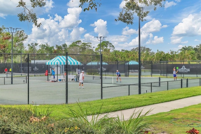 view of tennis court featuring fence