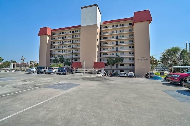 view of property featuring uncovered parking