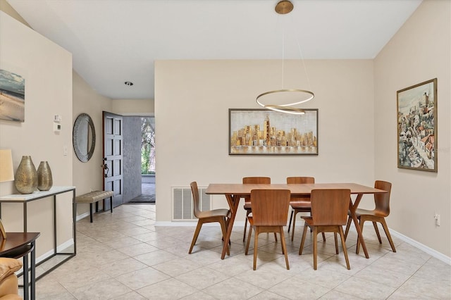 dining space featuring light tile patterned floors, visible vents, and baseboards