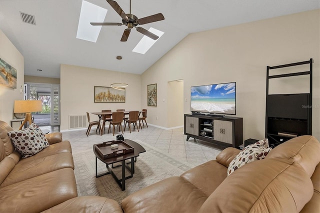 living room featuring a skylight, baseboards, visible vents, and light tile patterned flooring