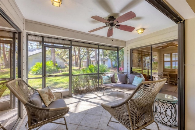 sunroom / solarium featuring a ceiling fan and a healthy amount of sunlight