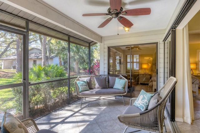 unfurnished sunroom featuring ceiling fan