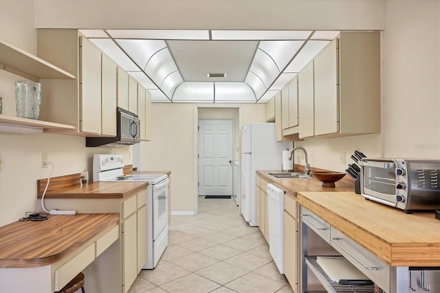 kitchen with open shelves, visible vents, a sink, butcher block countertops, and white appliances