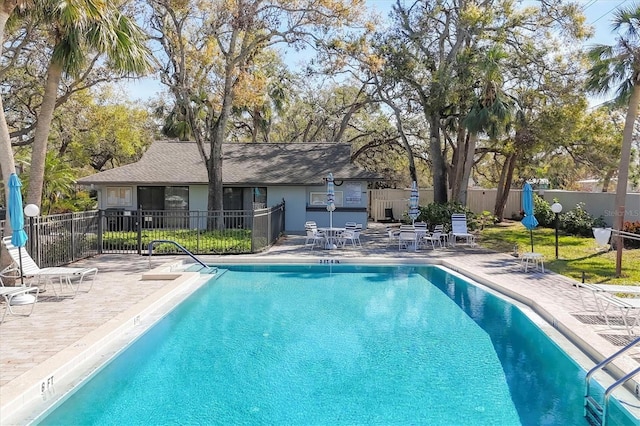 community pool featuring a patio area and fence