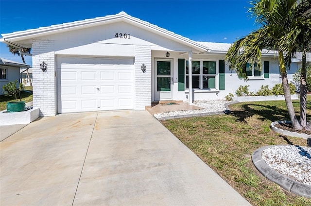 ranch-style home featuring brick siding, driveway, and an attached garage