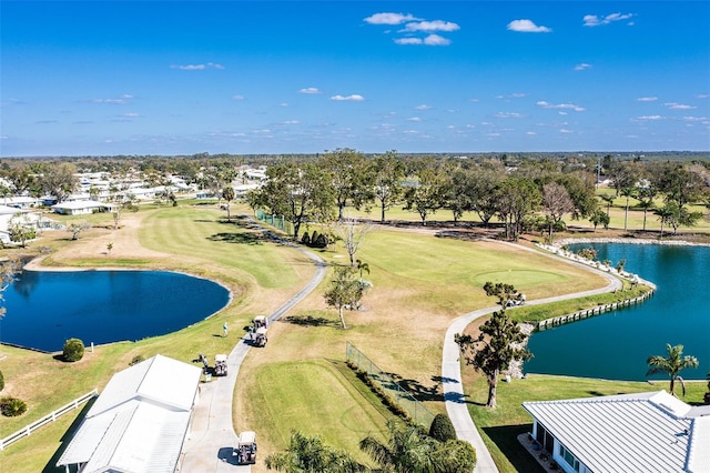 birds eye view of property with a water view and golf course view