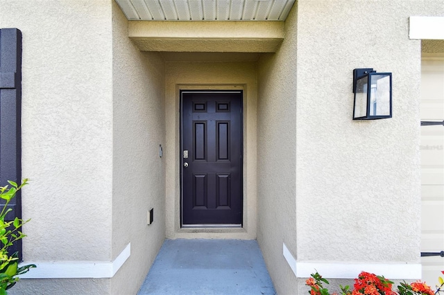 4918 Gray Owl Ter, Palmetto, FL 34221 - doorway to property featuring stucco siding