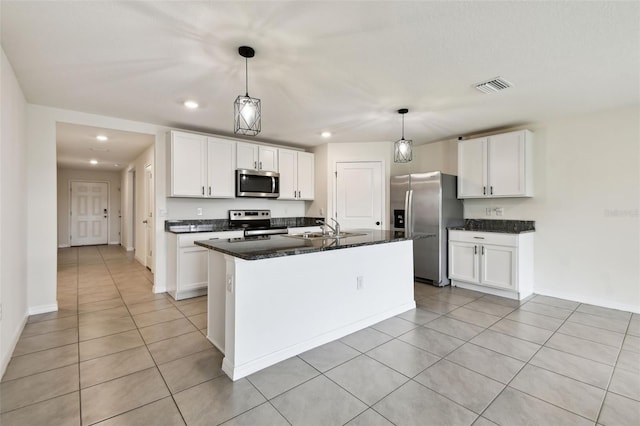 4918 Gray Owl Ter, Palmetto, FL 34221 - kitchen with appliances with stainless steel finishes, light tile patterned floors, recessed lighting, white cabinets, and an island with sink