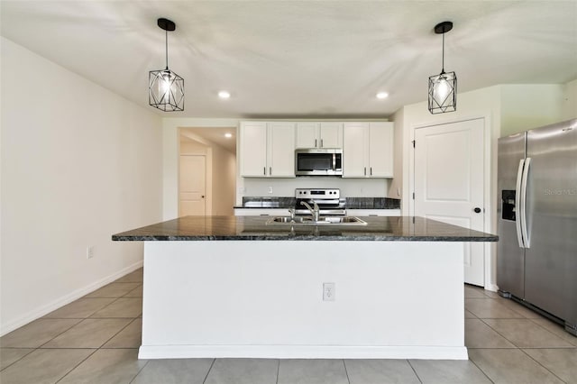 4918 Gray Owl Ter, Palmetto, FL 34221 - kitchen with stainless steel appliances, white cabinetry, light tile patterned floors, recessed lighting, and an island with sink