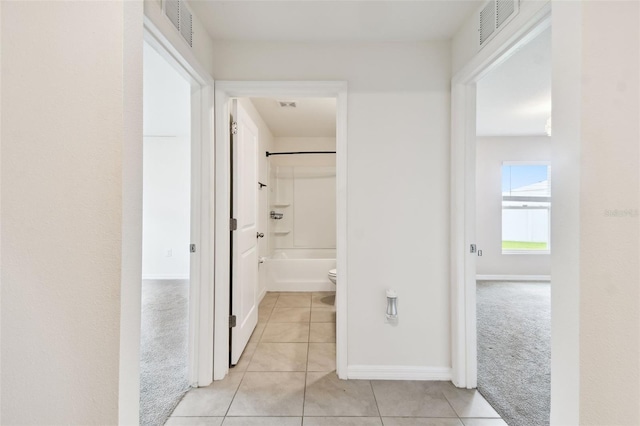 4918 Gray Owl Ter, Palmetto, FL 34221 - hallway featuring light carpet and light tile patterned floors