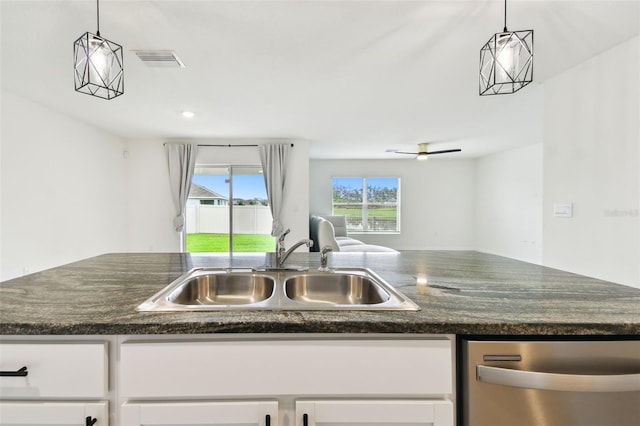 4918 Gray Owl Ter, Palmetto, FL 34221 - kitchen featuring stainless steel dishwasher, open floor plan, white cabinetry, and pendant lighting