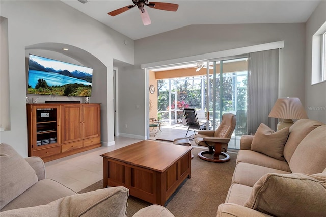 living area with lofted ceiling, visible vents, a ceiling fan, and baseboards