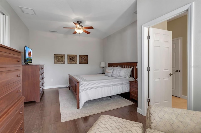 bedroom with visible vents, wood finished floors, a ceiling fan, and baseboards