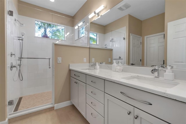 full bathroom with double vanity, a sink, visible vents, and a shower stall