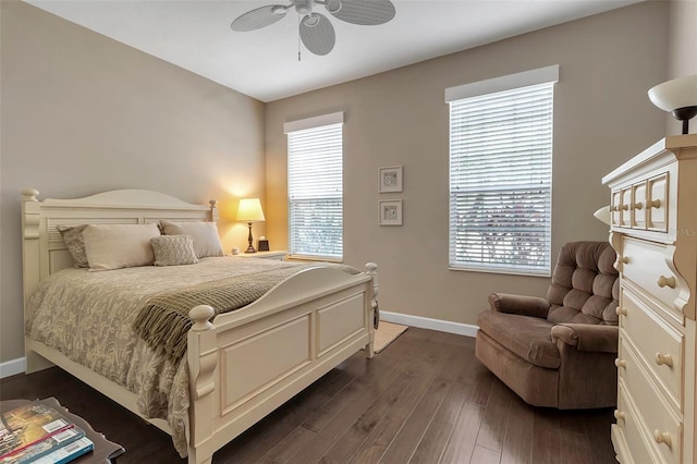 bedroom with dark wood-style floors, ceiling fan, and baseboards