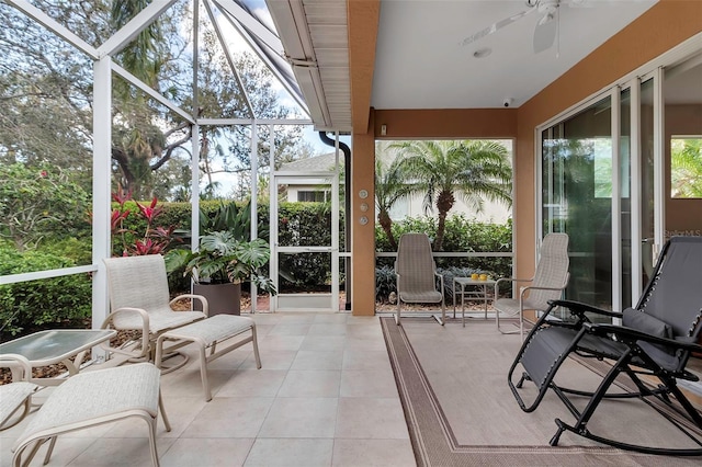 sunroom featuring ceiling fan