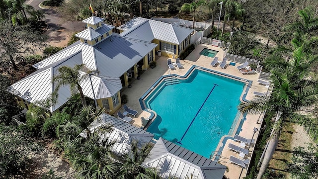 pool with a patio and fence