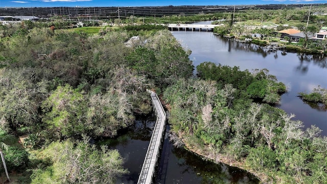 aerial view featuring a water view and a forest view