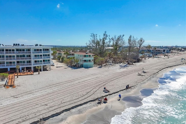 bird's eye view with a water view and a view of the beach