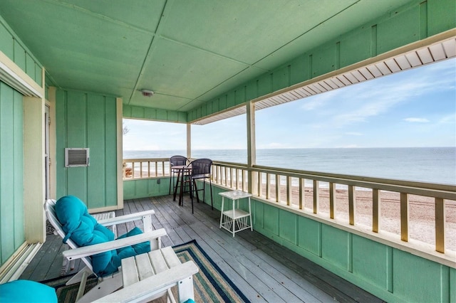 deck featuring a water view and a beach view