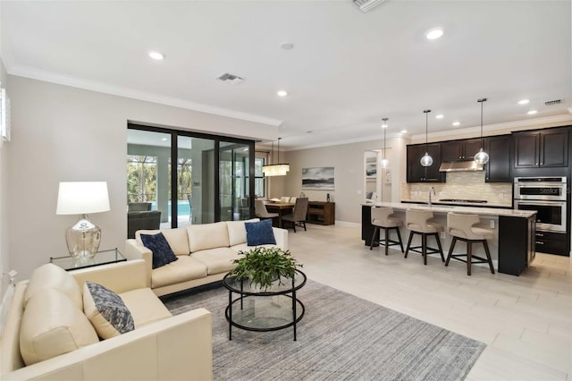 living area with recessed lighting, visible vents, crown molding, and baseboards